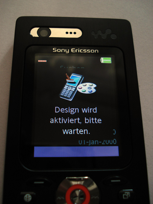 A model holds the new Sony Ericsson W880i mobile phone at the